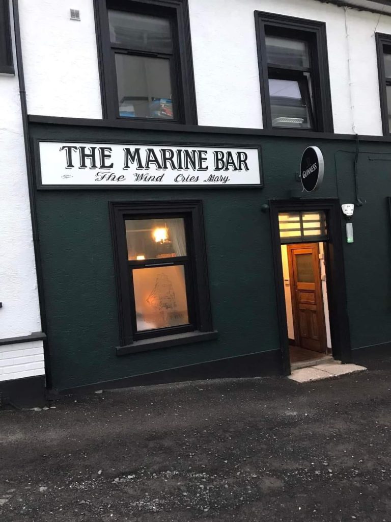 Warmly lit exterior view of the Marine Bar Whitehead